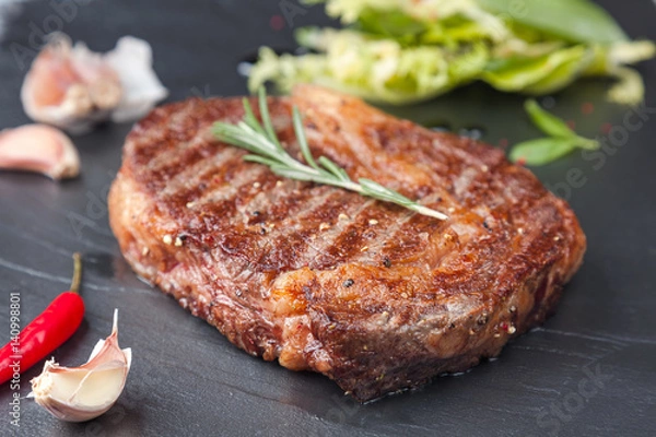 Obraz Juicy rib-eye on a stone table