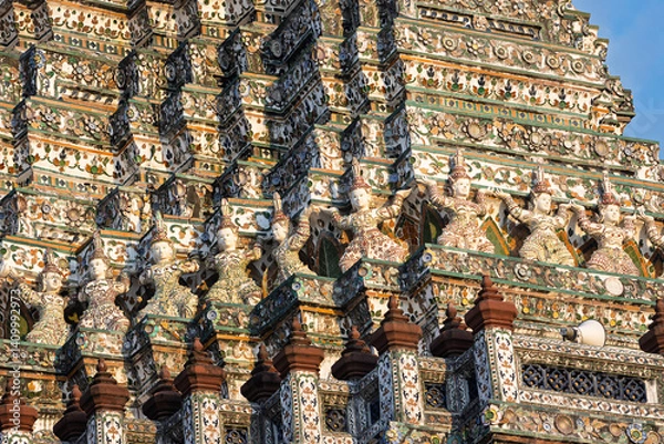 Fototapeta Close-up of colorful Ceramic Guardians Warriors decorating the Central prang of Wat Arun in Bangkok, Thailand. Elaborate porcelain patterns on Wat Arun or Temple of Dawn. Built in 1600s.