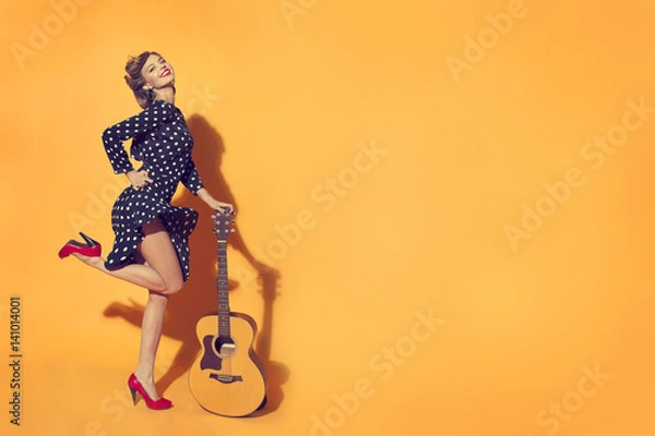 Obraz girl with guitar on yellow background in retro style