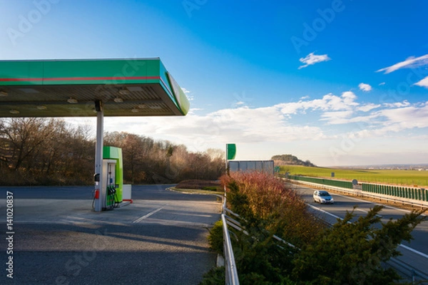 Obraz Petrol station on the motorway. Sunset at the gas station. Car traveling on the highway at sunset. Maximal speed. Sunset on the motorway.