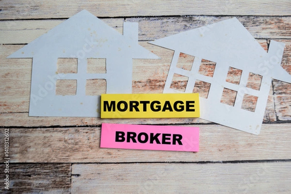 Fototapeta Concept of Mortgage Broker write on sticky notes isolated on Wooden Table.