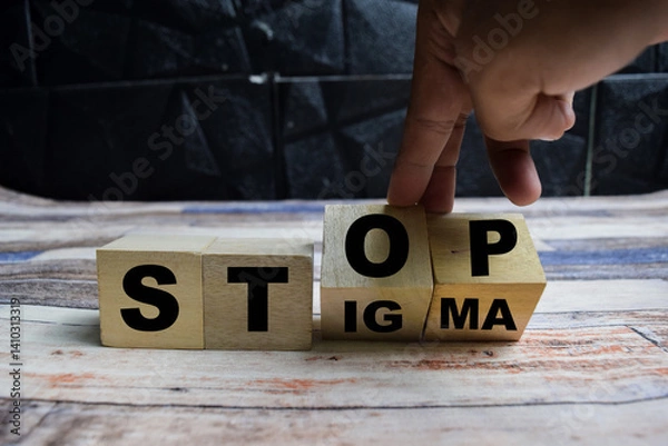 Fototapeta Concept word Stop stigma symbol, doctor turns with words stop stigma on wooden blocks on a wooden table