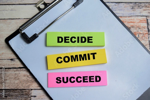 Fototapeta Concept of Decide Commit Succeed write on sticky notes isolated on Wooden Table.