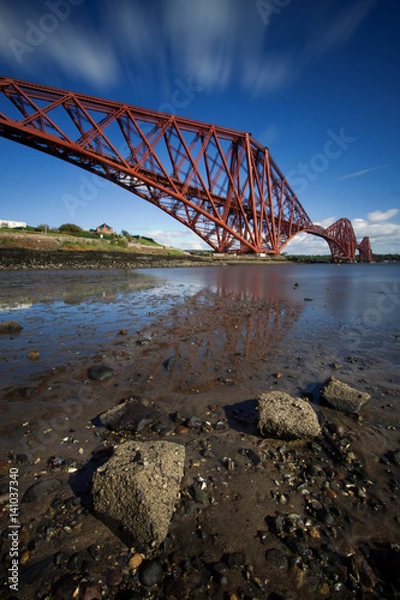 Fototapeta The Forth Rail Bridge is a cantilever railway bridge opened in 1890 that crosses the Firth of Forth between Edinburgh and Fife in Scotland. It is the second largest bridge of its kind in the world.