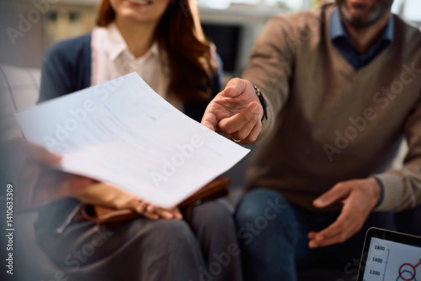 Obraz Close up of financial advisor offering contract to a couple during a meeting in the office.