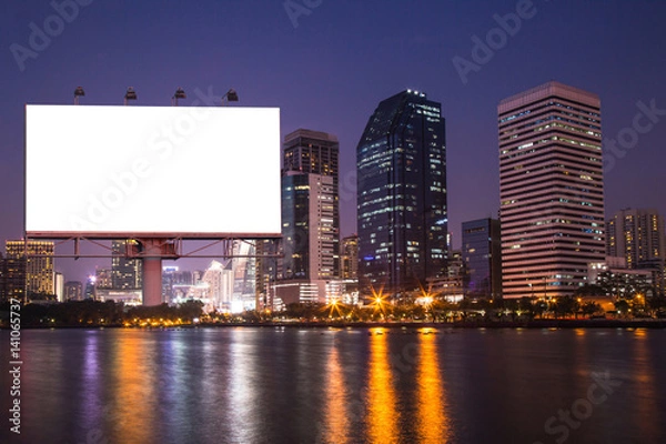 Fototapeta lake in the night city with white blank billboard