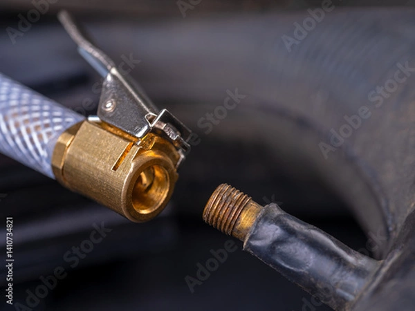 Fototapeta Inflating a wheel with a compressor.