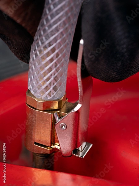 Obraz Inflating a wheel with a compressor.
