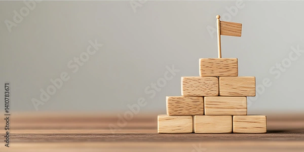 Obraz Wooden block tower with flag represents goals and success, achieved step by step. Strategy and planning are key for accomplishment.