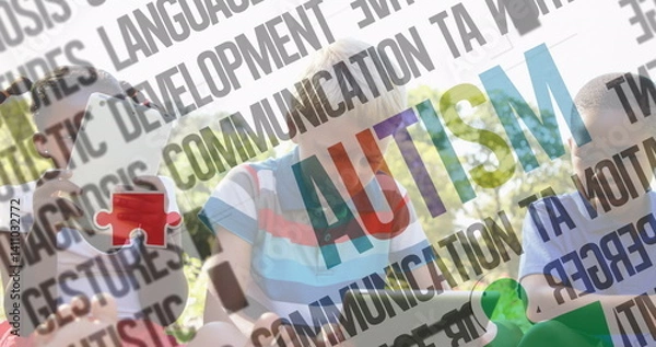 Fototapeta Image of colourful puzzle pieces and autism text over children using tablets