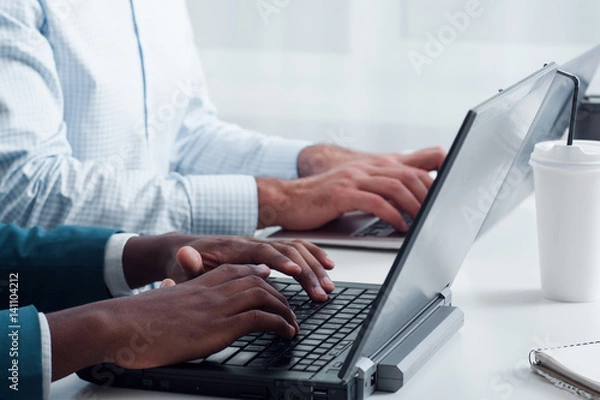 Obraz Programming using new technologies. Learning computer programs online. Multiethnic office workers