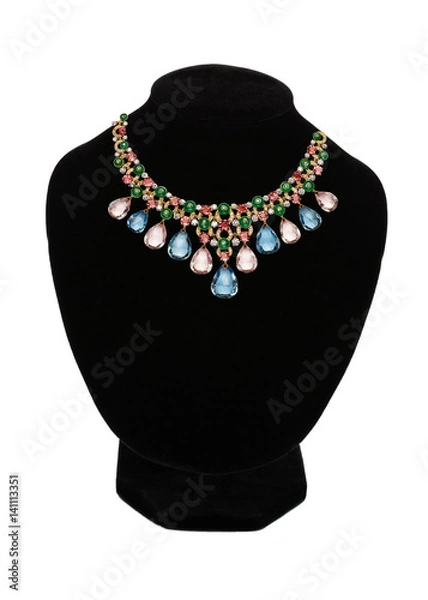 Fototapeta Pendant with red gem stones on black mannequin isolated on white