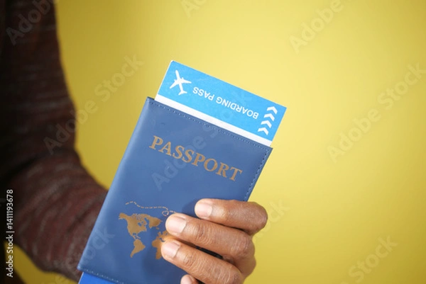 Obraz Holding a passport and boarding pass in preparation for travel
