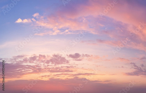 Fototapeta High-resolution image of a soft sunset sky with pastel pink, lavender, and gold tones. Gentle clouds and natural light glow. Dreamy and serene, suitable for beauty and wellness designs.