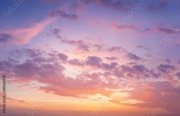 Obraz High-resolution image of a soft sunset sky with pastel pink, lavender, and gold tones. Gentle clouds and natural light glow. Dreamy and serene, suitable for beauty and wellness designs.