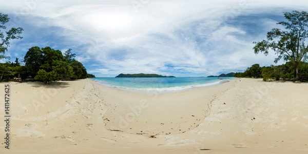 Fototapeta A pristine sandy beach stretches under a vast, cloud-filled sky, with gentle waves touching the shore. Anse Takamaka. Praslin, Seychelles. 360 panorama VR.