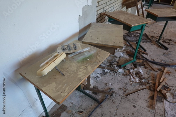 Fototapeta Abandoned Classroom with Broken Desks and Scattered Debris