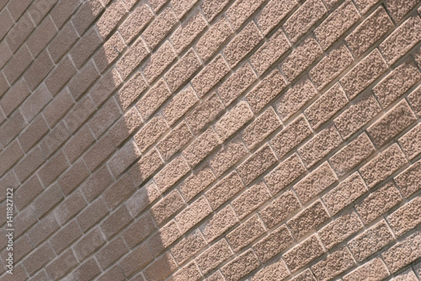 Fototapeta light beige brick wall with light and shadow architecture background