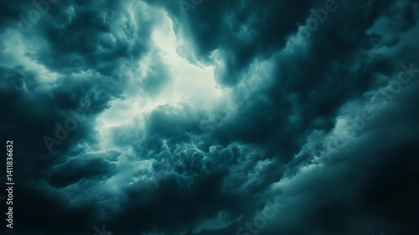 Fototapeta Storm clouds loom over the prairie, a vast sky in moody blues and greys, evoking nature's raw power and solitude.