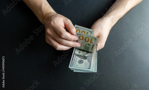 Fototapeta man counting hundred dollar bills. dollar investment and cost of living