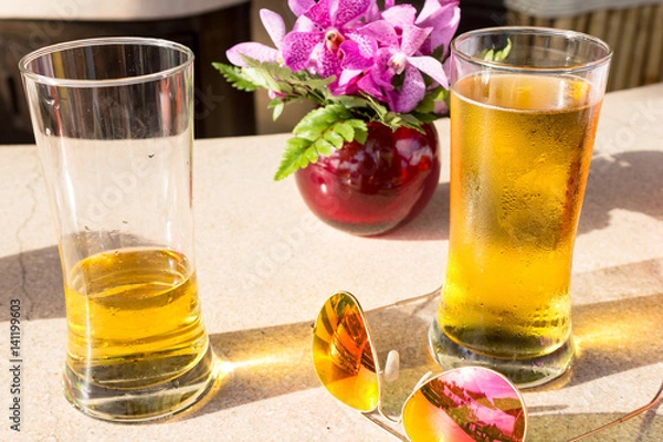Fototapeta Drinks and Sunglasses at a Beach Bar in Thailand
