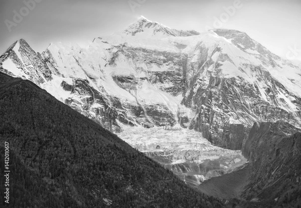Fototapeta Himalayas, Nepal - The famous hiking on the roof of the world called Annapurna Circuit in the Himalaya range mountain, with little village, buddhist stupa and mountains of 8000 meters.