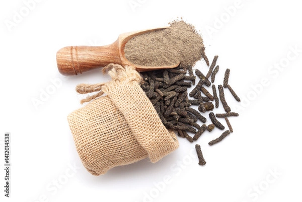 Obraz A scoop of organic long pepper (Piper longum) powder, along with long pepper fruits spilled out from a jute bag. Isolated on a white background.