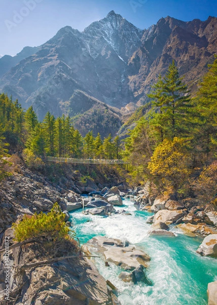 Fototapeta Himalayas, Nepal - The famous hiking on the roof of the world called Annapurna Circuit in the Himalaya range mountain, with little village, buddhist stupa and mountains of 8000 meters.