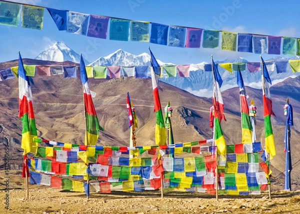 Fototapeta Himalayas, Nepal - The famous hiking on the roof of the world called Annapurna Circuit in the Himalaya range mountain, with little village, buddhist stupa and mountains of 8000 meters.