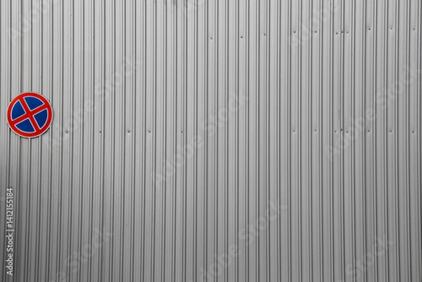 Fototapeta road sign stopping is not allowed. no stop. No Parking sign on a metal corrugated grey gray silver zinc fence.  no stopping allowed.