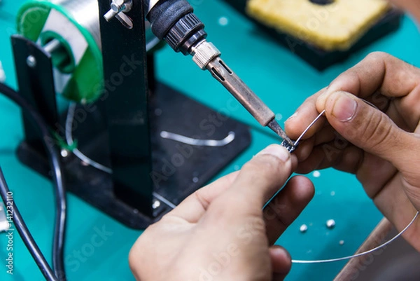 Fototapeta working is soldering cable
