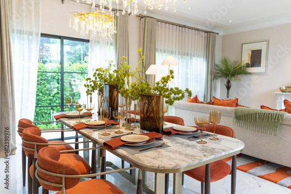 Fototapeta Beautiful luxurious traditional style modern dining room with bouquets of flowers on the table. Elegance dinning table with luxurious pendant.