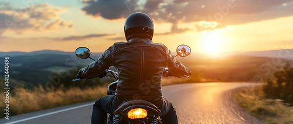 Fototapeta Riding into the Sunset: A biker on a motorcycle embraces the open road, the setting sun paints the sky with vibrant hues, embodying freedom and the thrill of the journey. 