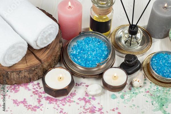 Fototapeta Spa treatment with candles and towel on wooden table, closeup