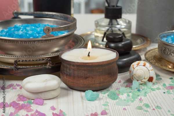 Fototapeta Spa treatment with candles and towel on wooden table, closeup