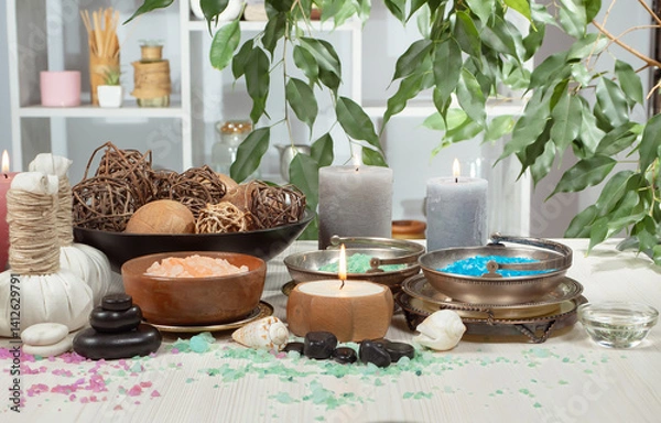 Fototapeta Spa treatment with candles and towel on wooden table, closeup
