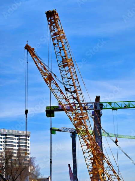 Fototapeta Multiple construction cranes illustration background
