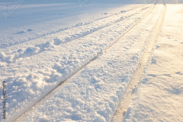 Fototapeta ski track, ski trail goes into the distance, on a clear sunny day, winter sports activity, skiing background