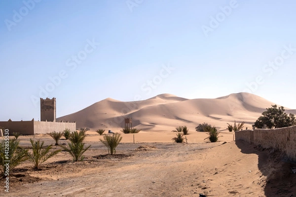 Obraz View of sand dunes in Merzouga, Traditional house in mud bricks, Morocco.  Erg Chebbi Sahara desert, North Africa
