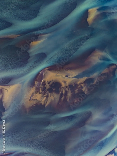Obraz erial abstract view of Icelandic river delta patterns at low tide, with vivid blue and golden tones blending in smooth organic shapes. Nature’s art captured from above.