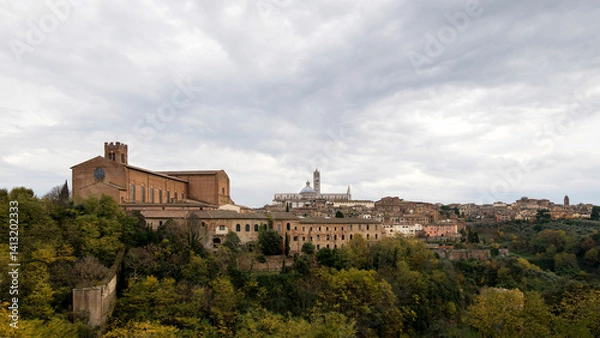 Obraz The ancient walls, the tower and the church of the City of Siena seen from afar. Italy