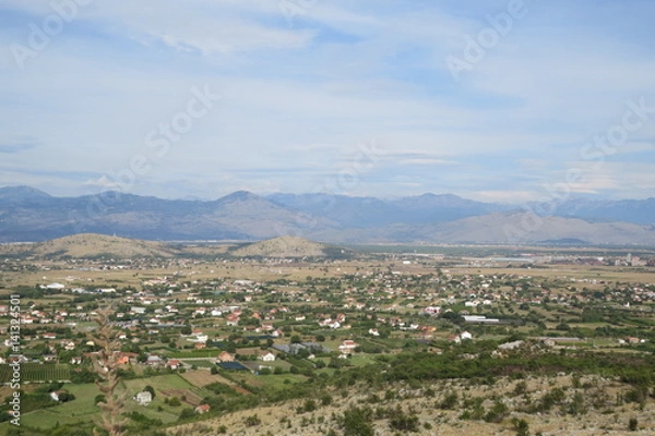 Fototapeta Green fields in suburban area