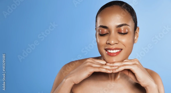 Obraz Smiling woman with glowing skin, no makeup, applies skincare treatment, attends spa cosmetology appointment, rejuvenates her skin, satisfied with hydrating and moisturizing effect, blue background