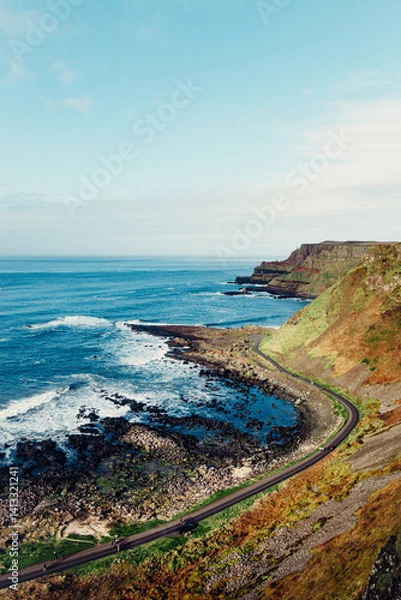 Obraz Moody Aerial View of Giant’s Causeway With Waves Crashing Into the Rocks and People Walking Around	