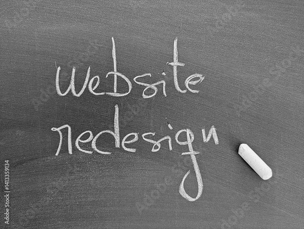 Fototapeta A chalkboard with the words "Website Redesign" written in chalk, suggesting a project or task related to website updates.