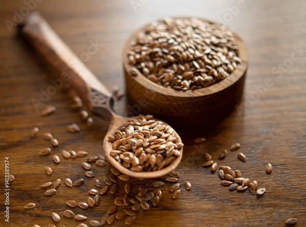 Fototapeta flax seeds in a rustic wooden bowl on a wooden table with copy space