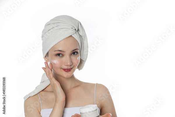 Obraz Young attractive asian woman with towel on head on light background with good skin. Concept of facial care after shower, moisturize skin