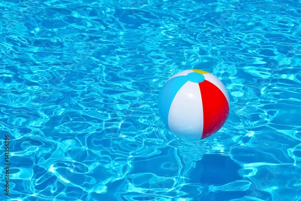 Fototapeta Colorful inflatable ball floating in swimming pool