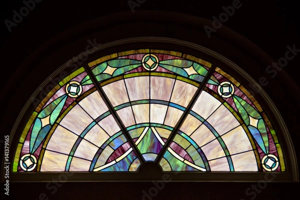 Obraz Circle top shaped window with elegant patterned stained glass.