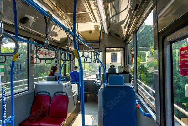 Fototapeta Riding Public Bus Through Green Landscape with Passengers and Safety Features